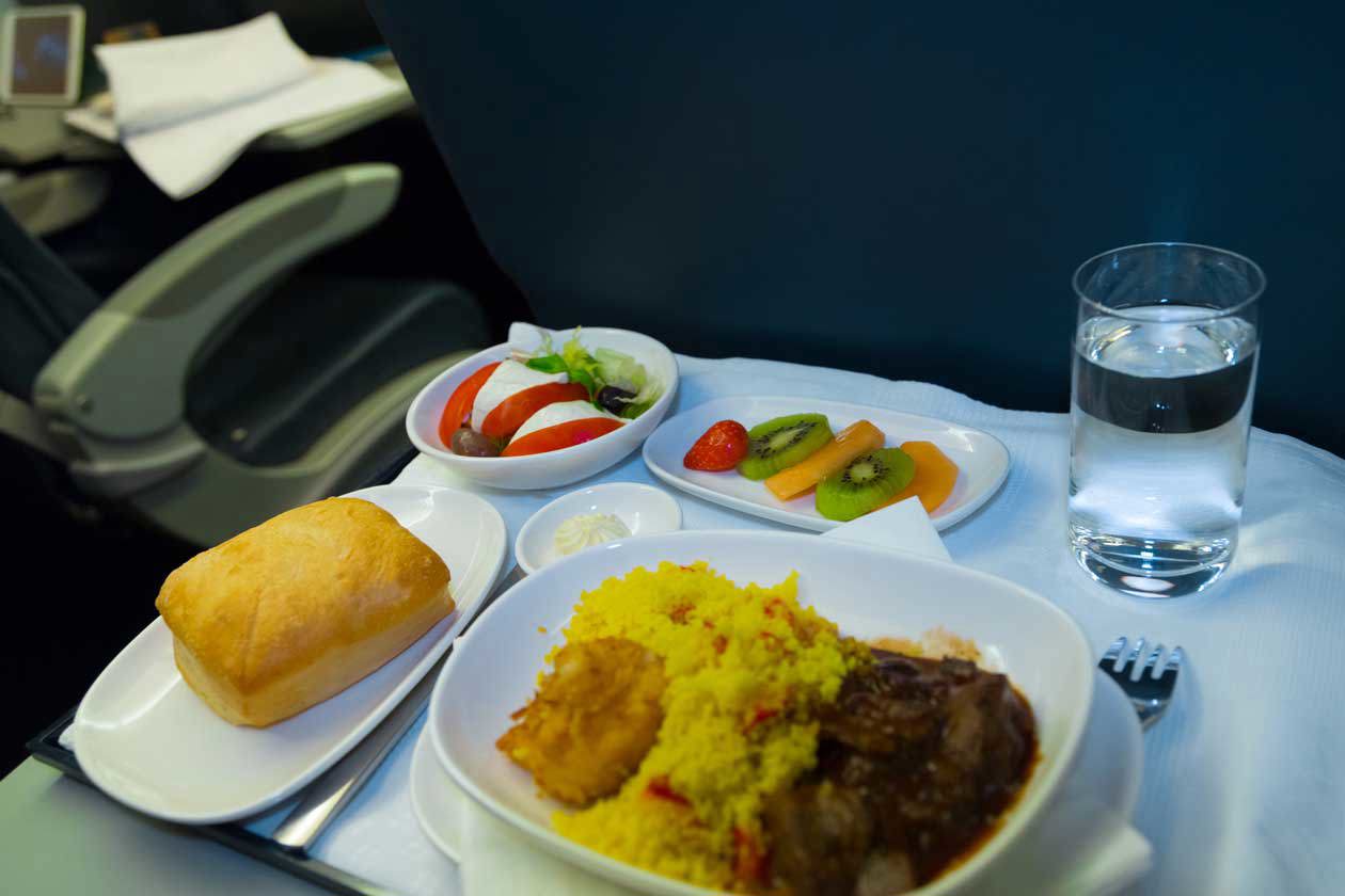 Lunch on board an airplane. Copyright © Sisterscom.com / YAYImages / Depositphotos