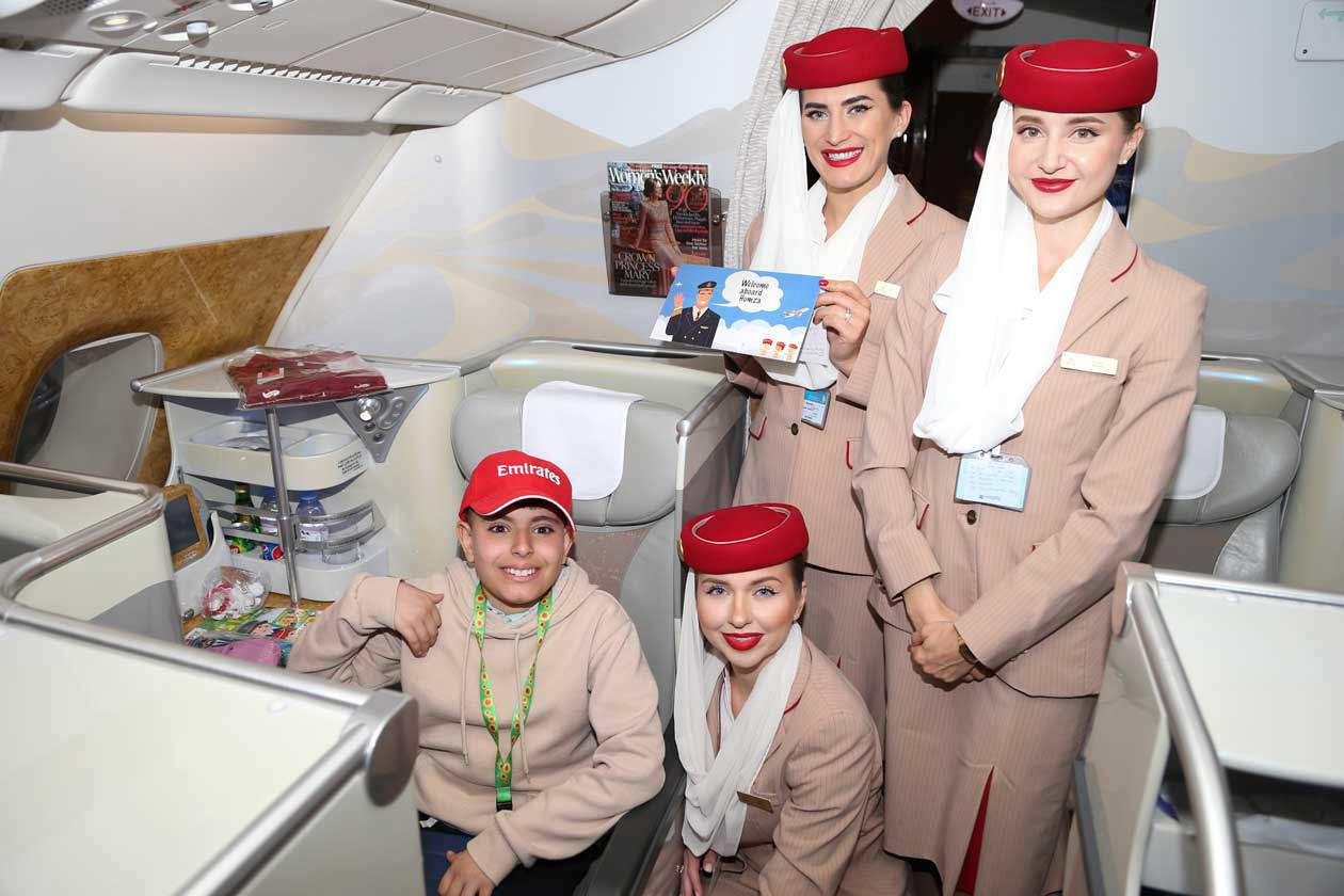 Emirates superfan Humza meets the cabin crew. Copyright © Ufficio Stampa Emirates Airlines / The Emirates Group
